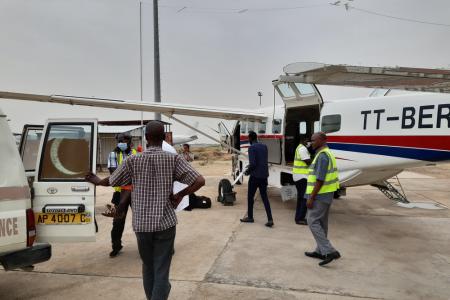 Staff getting ready to unload the patient into the waiting ambulance
